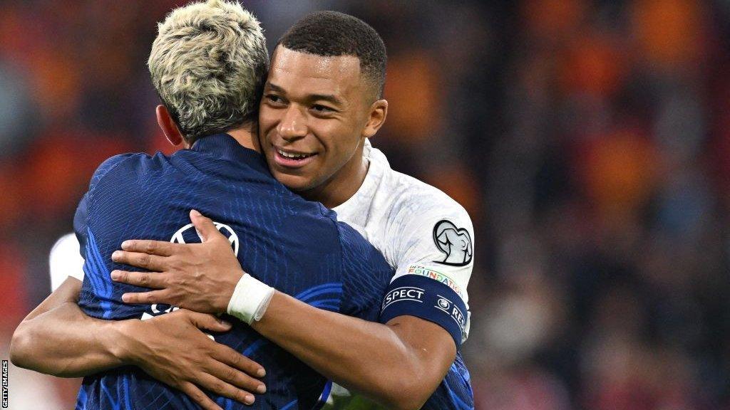 Kylian Mbappe celebrates France's win by hugging team-mate Antoine Griezmann