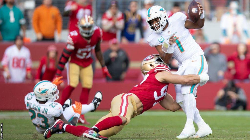 Tua Tagovailoa is tackled by Nick Bosa