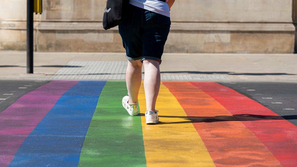 Person walking over the rainbow crossing in Battersea