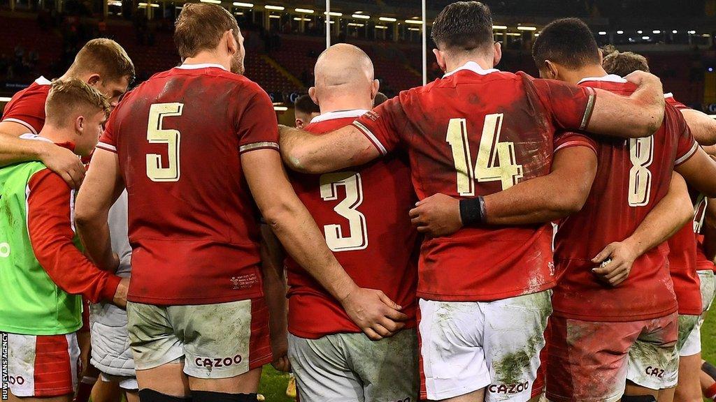 Wales players in a post-match huddle