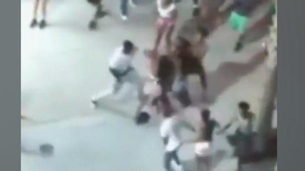 A video captures the moment a street fight became the scene of a shooting that left seven injured.