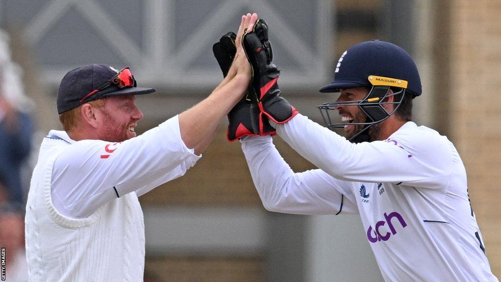 England's Jonny Bairstow (L) celebrates with England's Ben Foakes after catching the ball to take the wicket of New Zealand's Devon Conway (unseen) for 52 runs on day 4 of the second Test cricket match between England and New Zealand at Trent Bridge cricket ground in Nottingham, central England, on June 13, 2022.