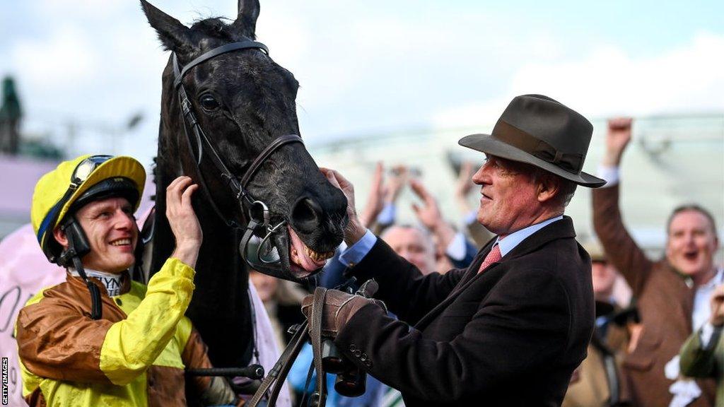 Jockey Paul Townend and trainer Willie Mullins with Galopin Des Champs after winning the Gold Cup