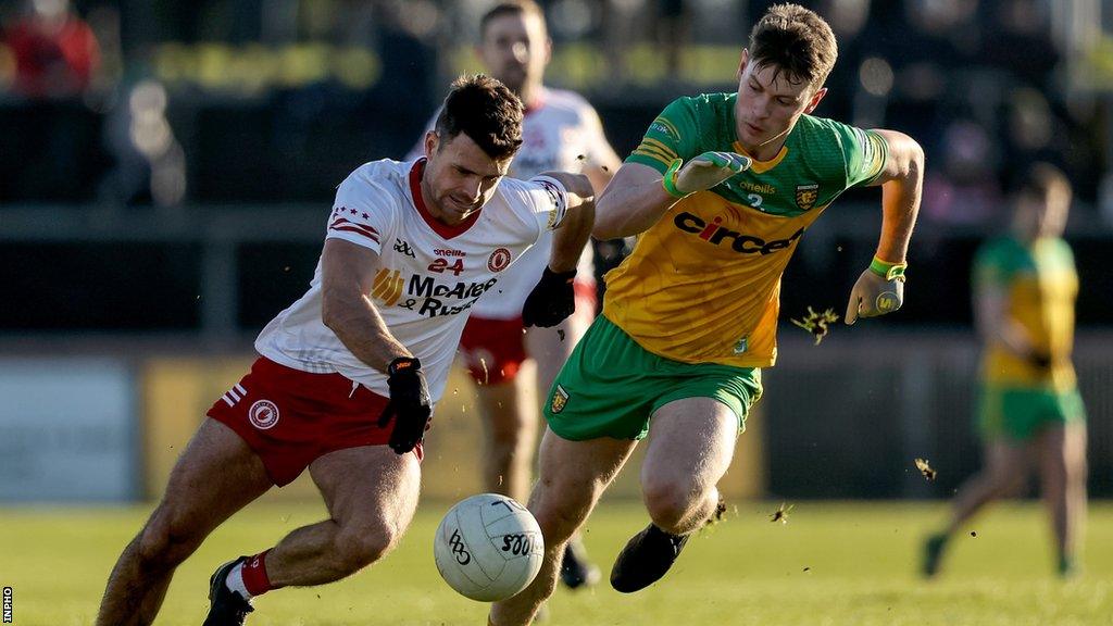 Tyrone's Darren McCurry attempts to speed away from Donegal's Mark Curran