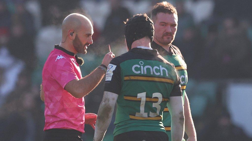 Fraser Dingwall of Northampton Saints is shown a red card after a collision with Dillyn Leyds