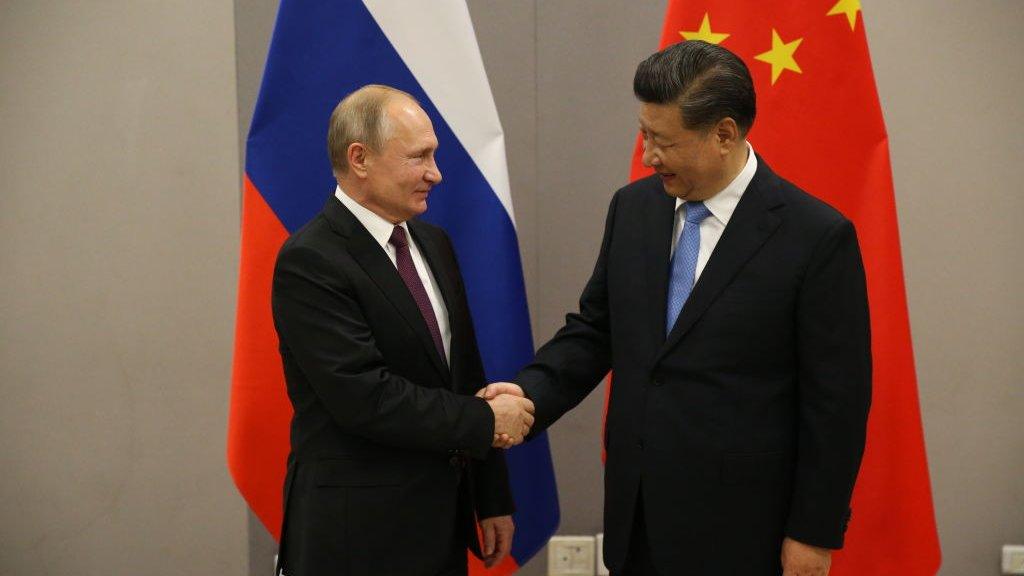 Russian President Vladimir Putin (L) greets Chinese President Xi Jinping (R) during their bilateral meeting on November 13, 2019 in Brasilia, Brazil. The leaders of Russia, China, Brazil, India and South Africa have gathered in Brasilia for the BRICS leaders summit.