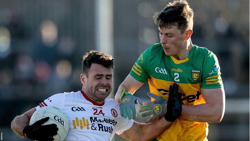 Donegal's Mark Curran challenges Darren McCurry during the Football League game in early February