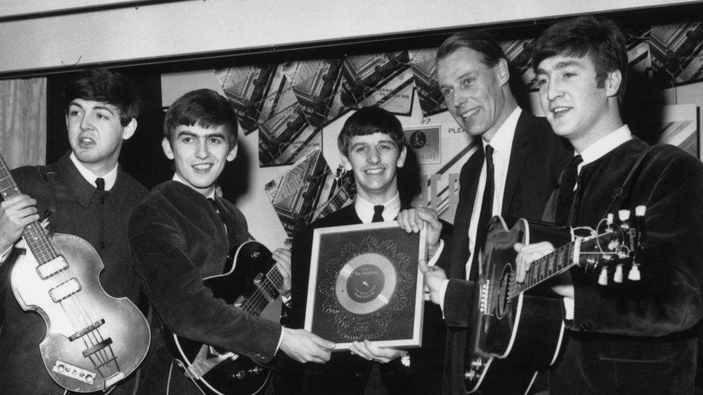 The Beatles with record producer George Martin