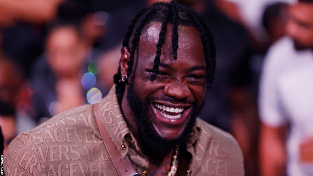 Deontay Wilder smiles at ringside