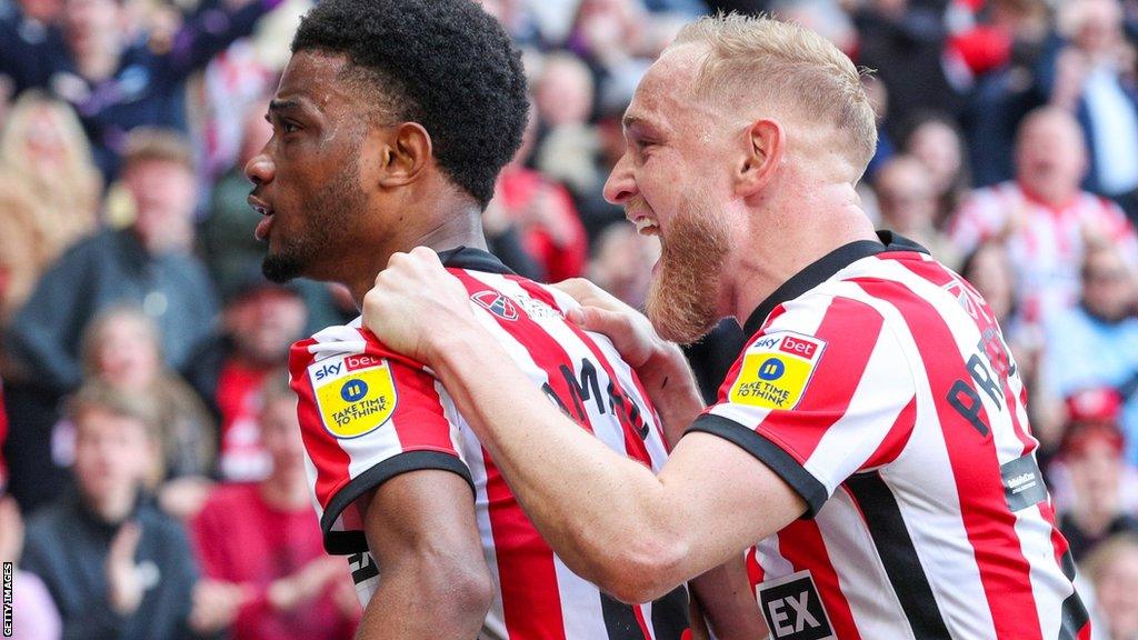 Amad Diallo (left) and Alex Pritchard celebrate the forward's goal for Sunderland against Luton