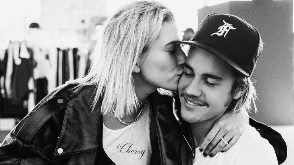 Hailey Baldwin kissing Justin Bieber on the cheek