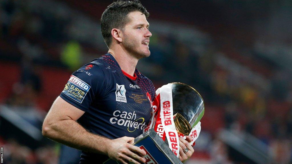 Lachlan Coote cradles the Super League Grand Final trophy