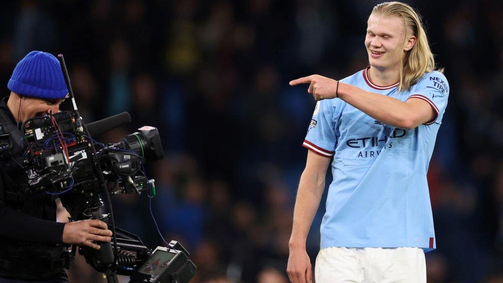 Manchester City's Erling Haaland points at TV camera