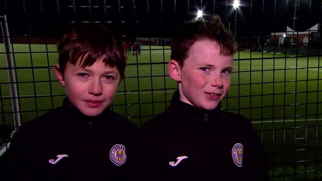 Kids-standing-beside-football-pitch.