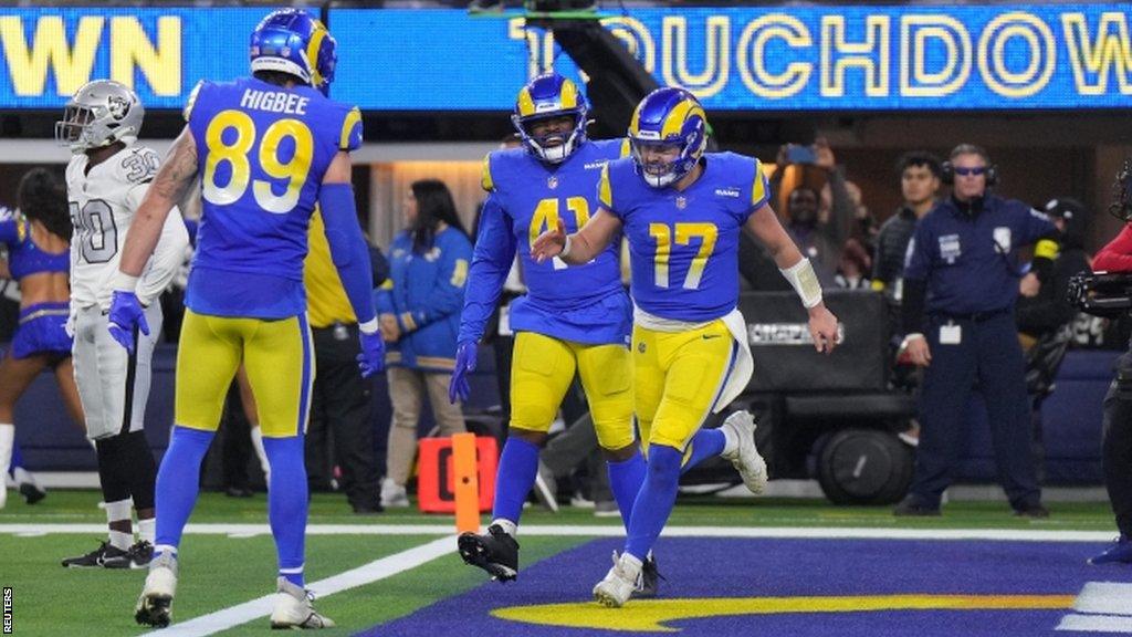 Tyler Higbee celebrates a touchdown with Baker Mayfield