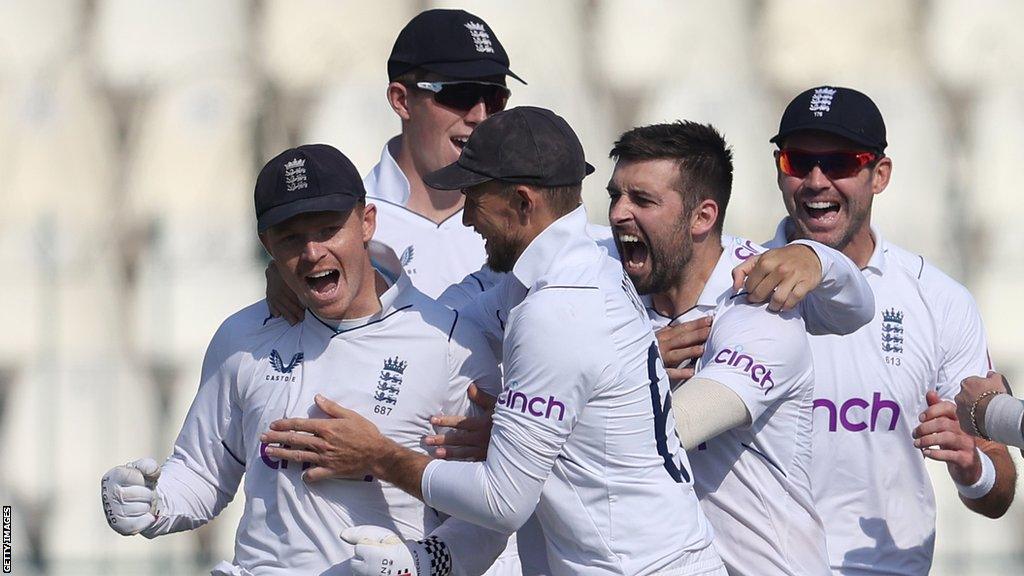 England players celebrate after Mark Wood takes a wicket