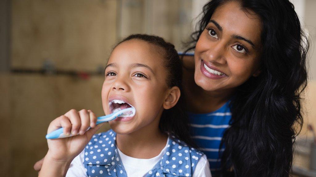 parent-halping-child-brush-teeth