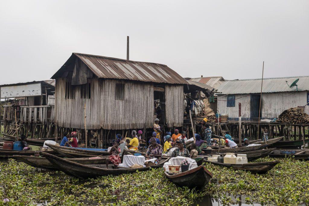 Boats gather outside a house on stilts