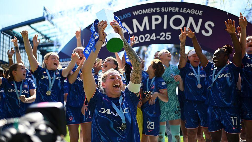 Chelsea players celebrating becoming Women's Super League champions.