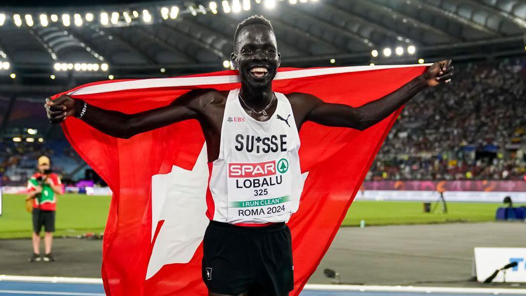 Dominic Lokinyomo Lobalu of Switzerland celebrates after finishing the Men's 5000 Metres during day six of the 26th European Athletics Championships - Rome 2024 at Stadio Olimpico on June 12, 2024 in Rome, Italy.