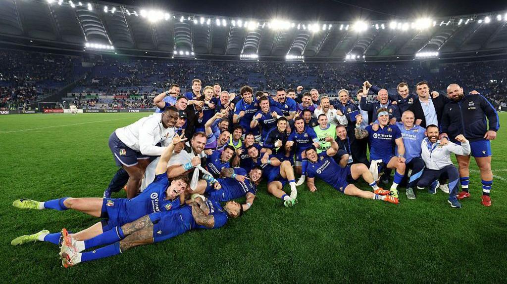 Italy team get a photo at full-time
