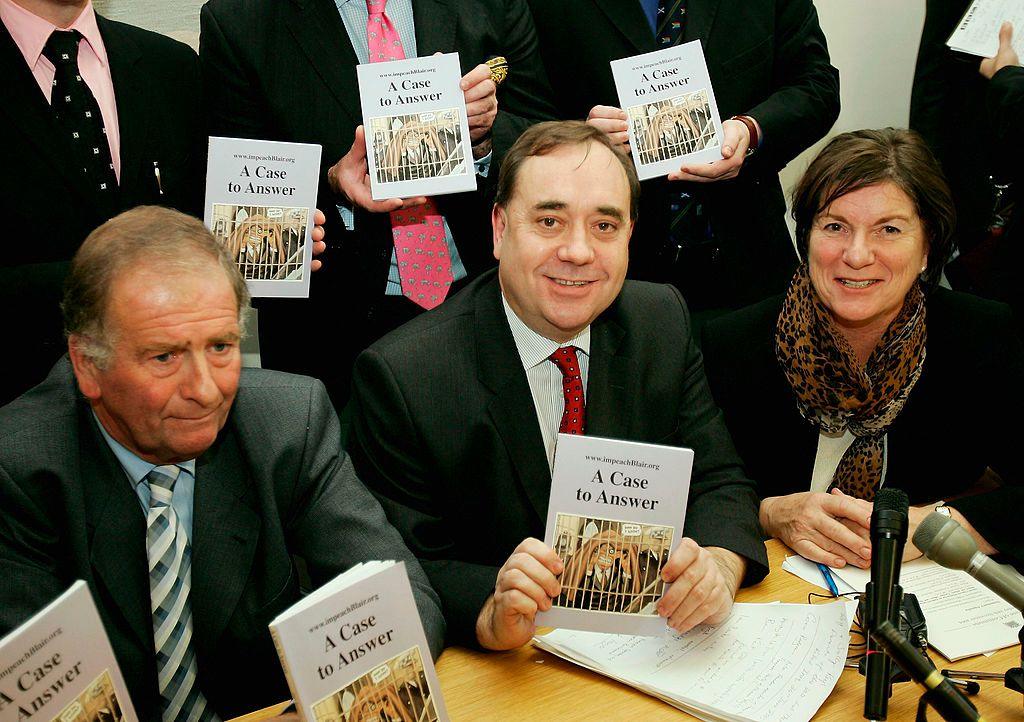 Alex Salmond surrounded by a group of other MPs holding up copies of a book making the case for the impeachment of Tony Blair