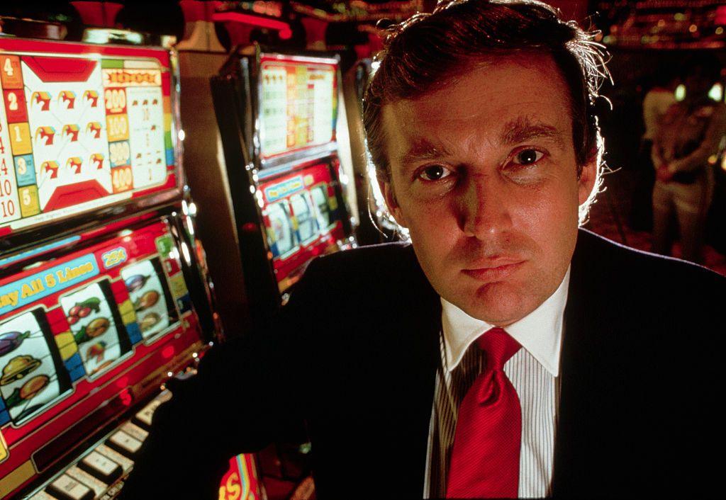 Donald Trump poses in front of slot machines at the opening of the Taj Mahal casino in Atlantic City, New Jersey.