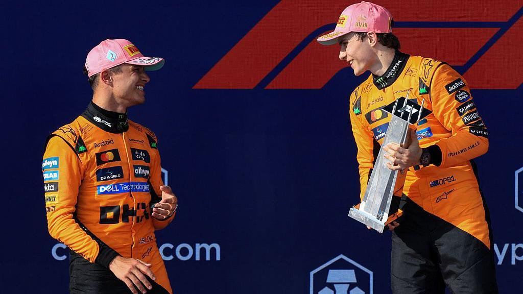 McLaren's Lando Norris and Oscar Piastri on the podium at the Miami Grand Prix