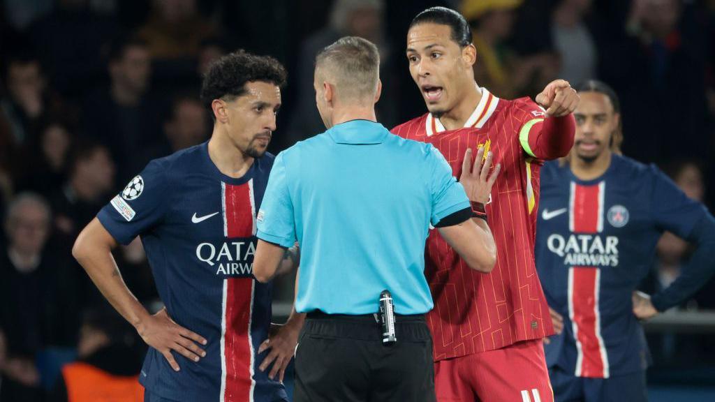 Marquinhos and Virgil van Dijk talk to referee Davide Massa