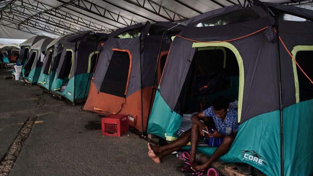 Migrants at the Dr Alfredo Pumarej temporary shelter as they wait for appointments for temporary visas near the US-Mexico border in Matamoros, Tamaulipas, Mexico, on 14 September 2024