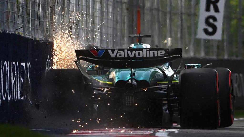 A rear view of the Aston Martin of Lance Stroll as it hits the wall and sparks fly during second practice for the Canadian Grand Prix