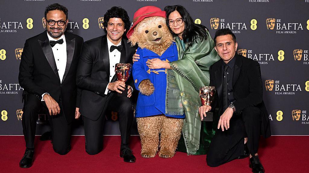 Paddington Bear poses with Alan McAlex, Farhan Akhtar, Lakshmipriya Devi and Ritesh Sidhwani, winners of the Best Children and Family Film award for "Boong"