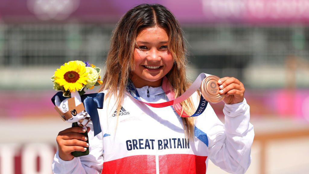 Skateboarder Sky Brown holding up her bronze medal at Tokyo 2020