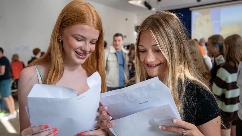 Two female students receive their GCSE results