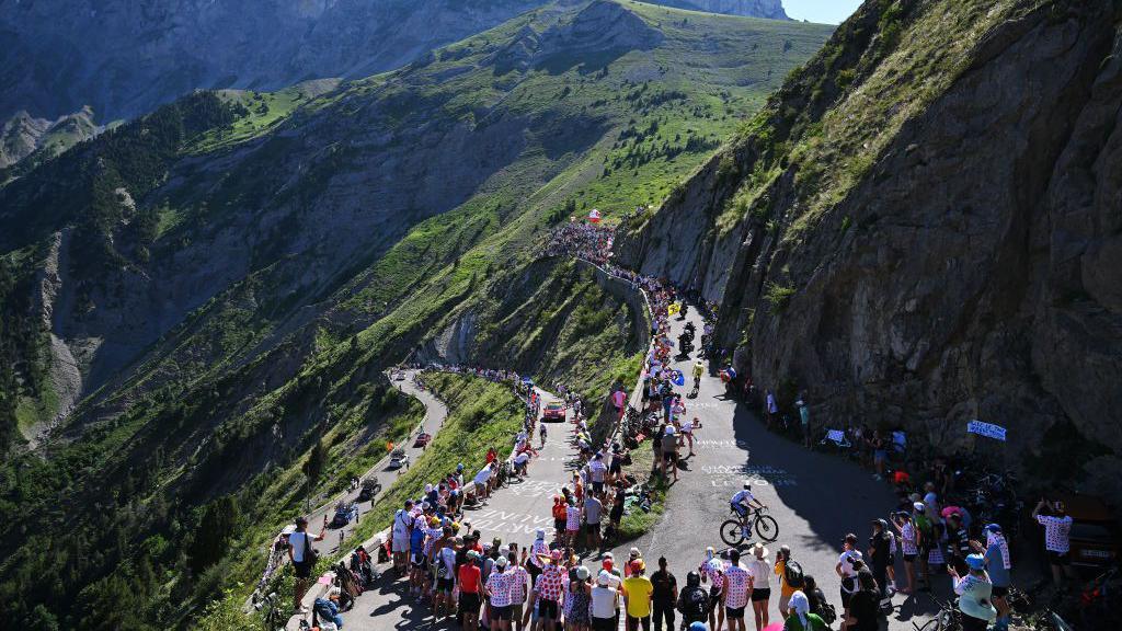 Tour de France cyclists making their way through the Alps.