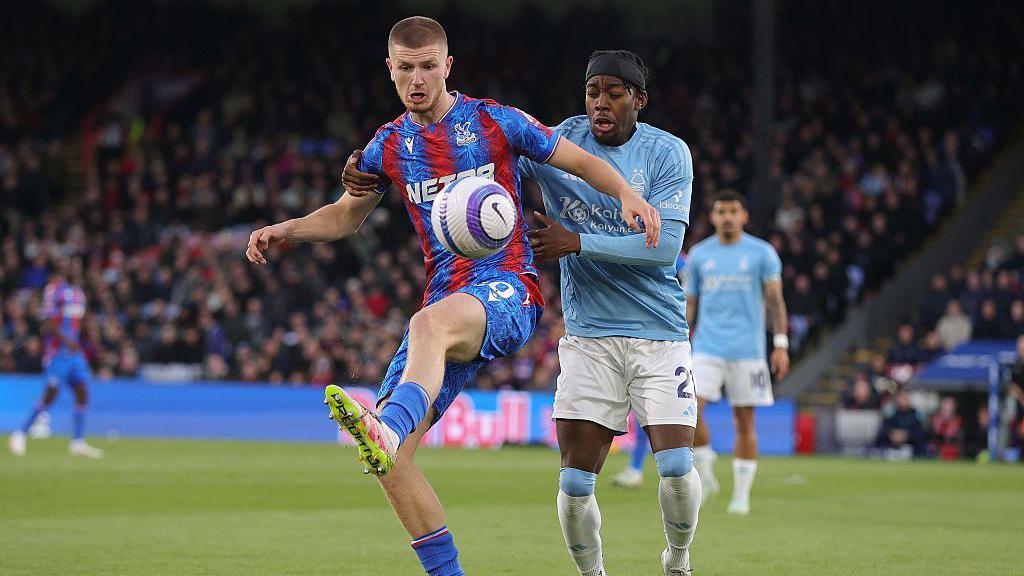 Adam Wharton of Crystal Palace battles for the ball with Anthony Elanga of Nottingham Forest 