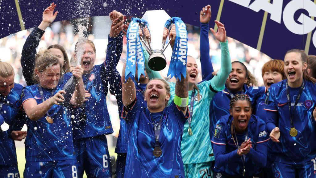 Millie Bright lifts the trophy as Chelsea celebrate winning the Women's League Cup