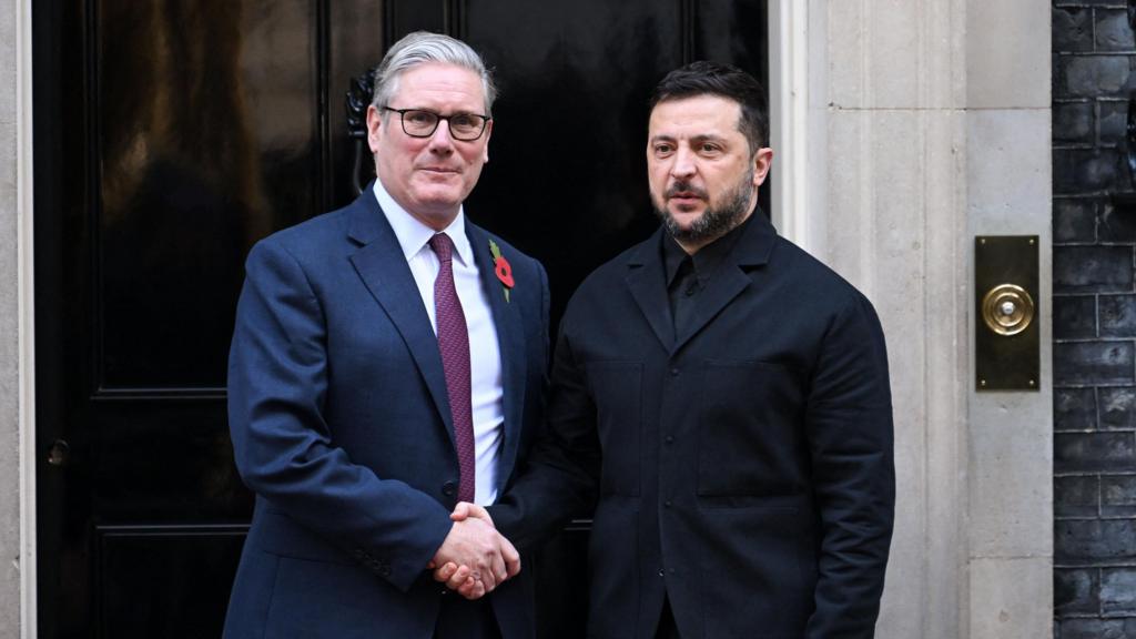 Starmer (L) and Zelensky (R) shake hands as they pose for pictures outside Number 10