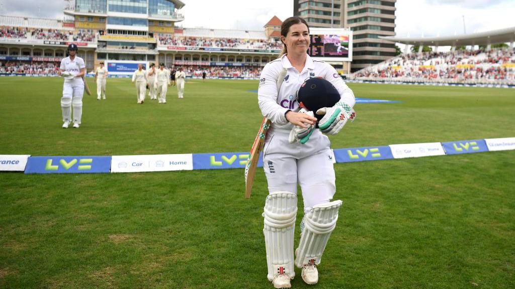Tammy Beaumont walking off the field in whites