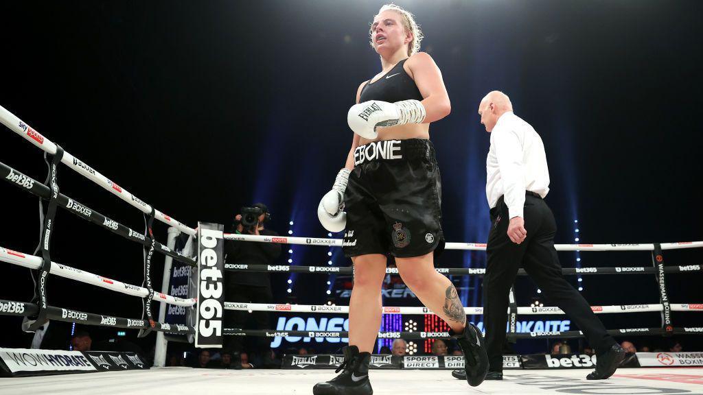Ebonie Jones walks back to her corner at the end of a round