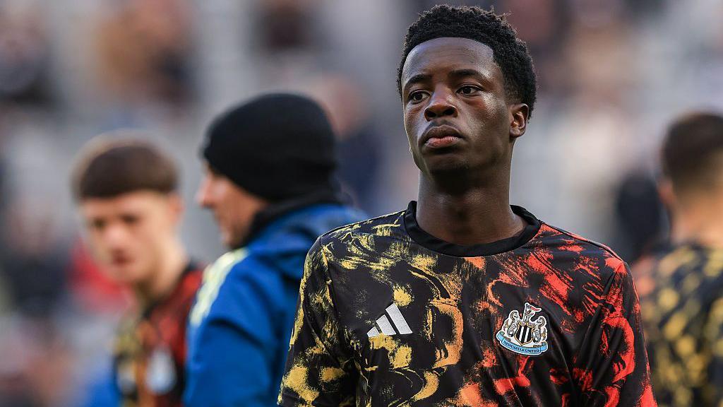 Sam Alabi wearing a Newcastle training top