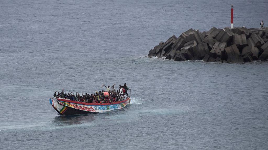 An image of dozens of migrants on a boat 