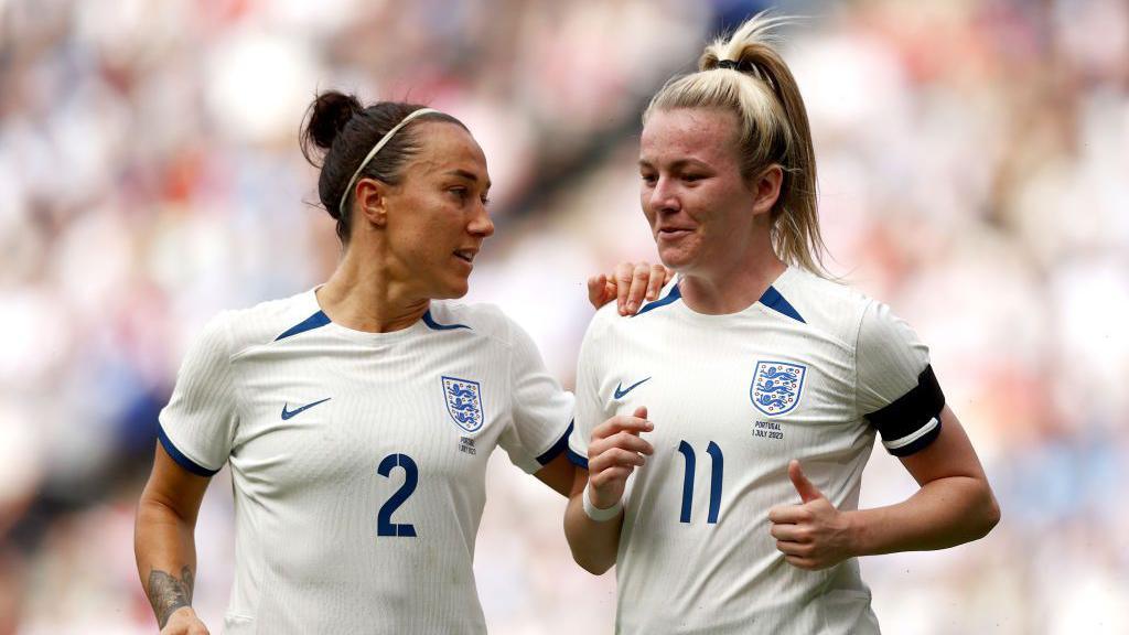 Lucy Bronze and Lauren Hemp of England talk during a friendly match between England and Portugal