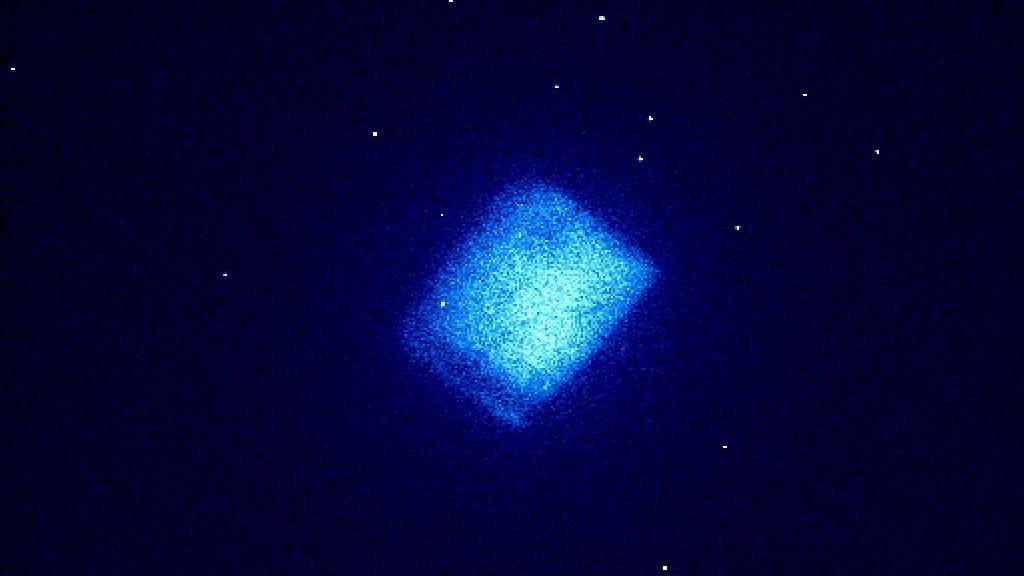 Carbon-14 diamond battery sample looks like a hazy blue square surrounded by tiny white dots 