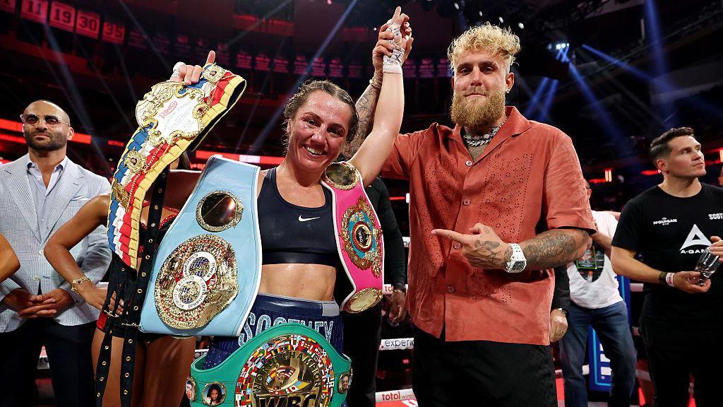 Ellie Scotney having her hand raised by Jake Paul