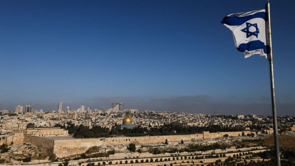  An Israeli flag flies on the Mount of Olives overlooking the Al Aqsa mosque compound and the city skyline in Jerusalem in April 2024