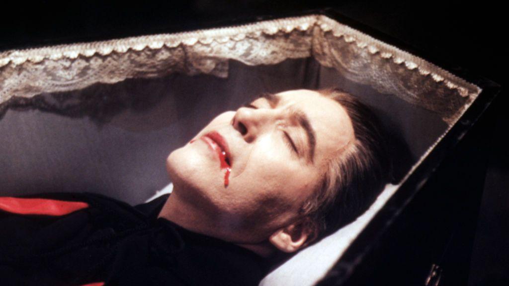 Actor Chritsopher Lee playing Dracula lying in a coffin