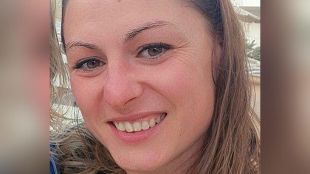 Woman with brown hair smiles for the camera