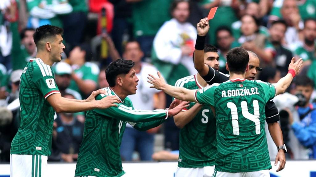 Referee Wilton Sampaio issues a red card to Cesar Montes #3 of Mexico