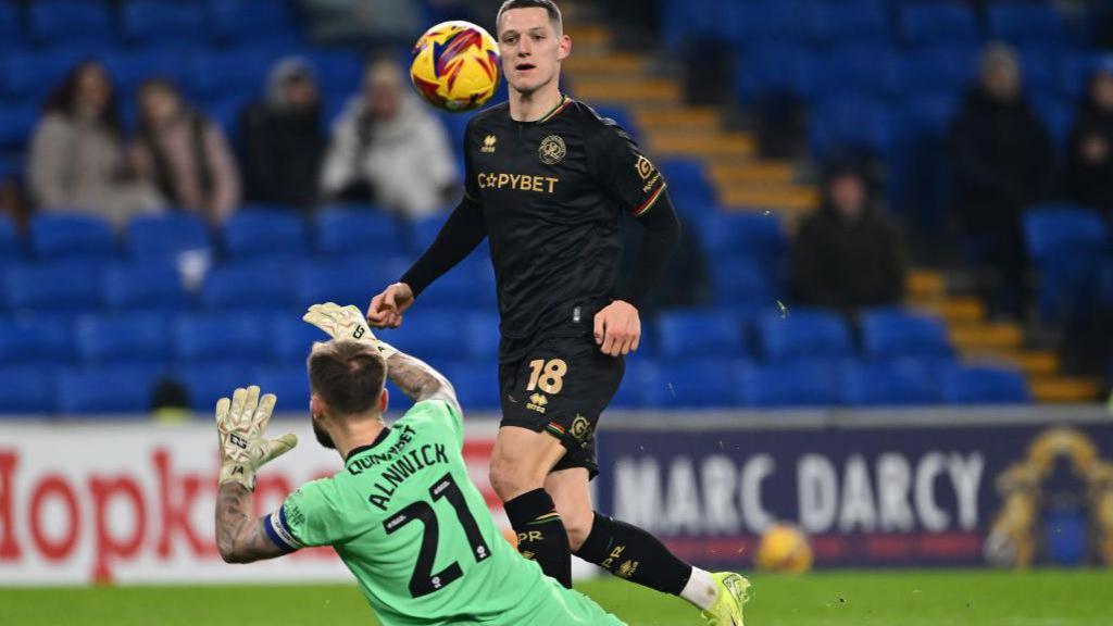 QPR striker Zan Celar chips goalkeeper Jak Alnwick to score his second goal against Cardiff City